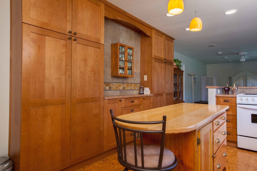 Eat-in kitchen - mid-sized transitional l-shaped eat-in kitchen idea in Seattle with shaker cabinets, medium tone wood cabinets and an island
