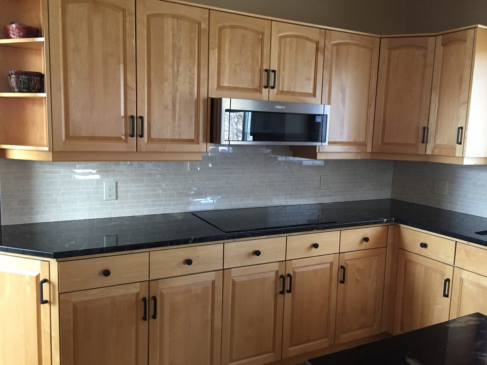 Porcelain tile kitchen photo with quartz countertops, ceramic backsplash and gray countertops