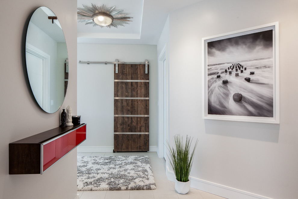 Mid-sized modern foyer in Miami with white walls, ceramic floors, a dark wood front door and white floor.