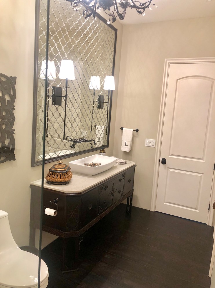 Mid-sized transitional bathroom in San Diego with furniture-like cabinets, dark wood cabinets, an open shower, a one-piece toilet, mirror tile, beige walls, dark hardwood floors, a vessel sink, quartzite benchtops, brown floor, an open shower and white benchtops.
