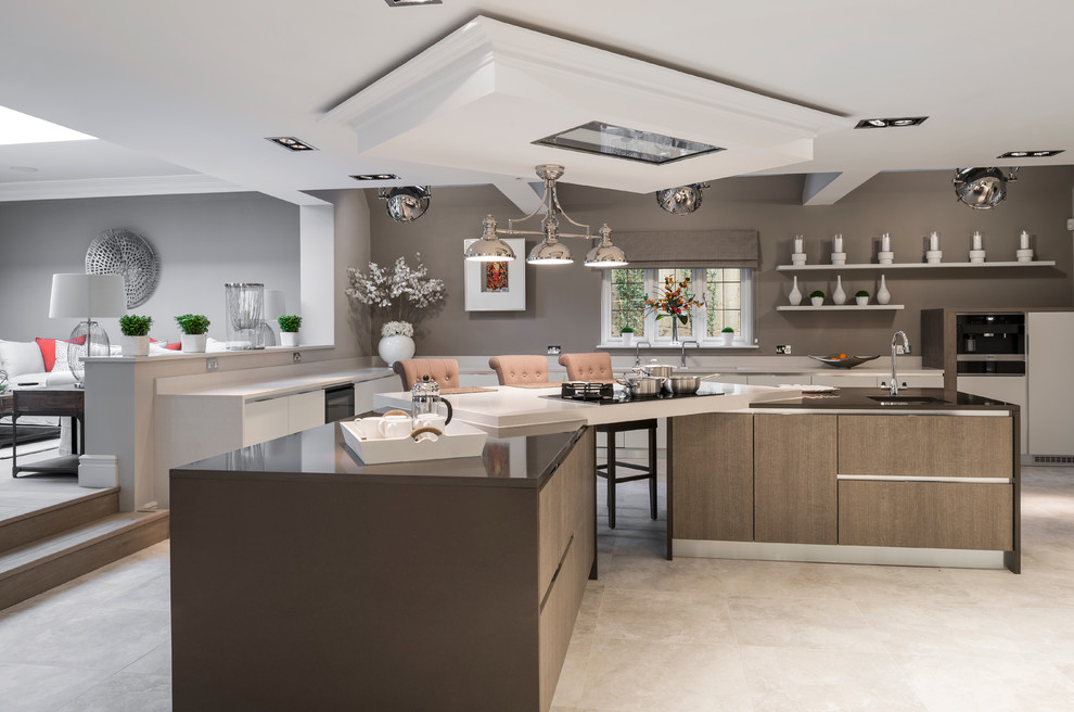 Inspiration for an expansive contemporary kitchen in Berkshire with flat-panel cabinets and multiple islands.