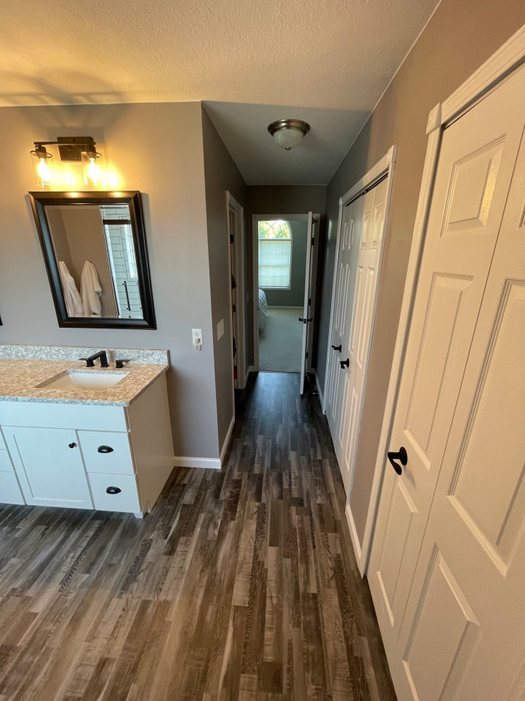 Mid-sized transitional white tile and subway tile wood-look tile floor and brown floor powder room photo in Other with flat-panel cabinets, white cabinets, beige walls, an undermount sink, quartz countertops, beige countertops and a freestanding vanity