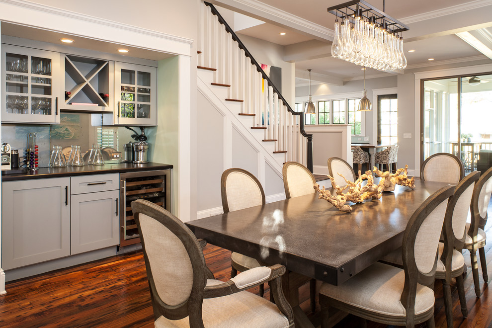 This is an example of a transitional dining room in Atlanta with grey walls and dark hardwood floors.