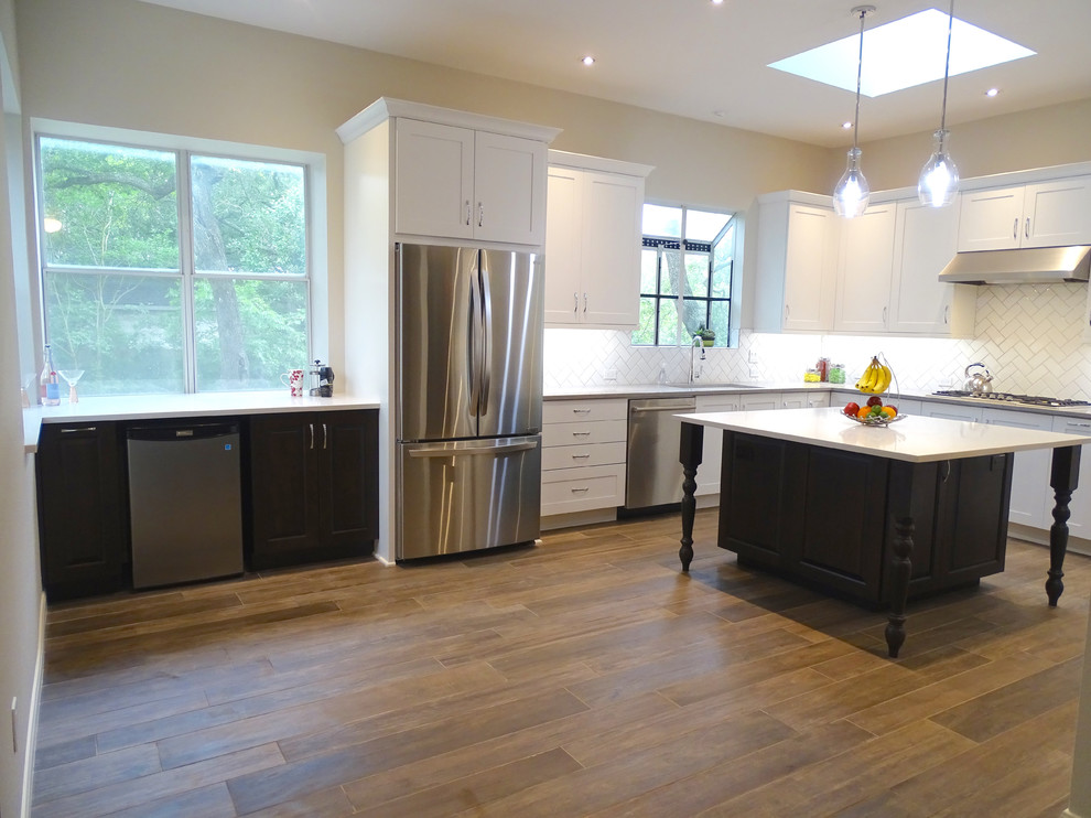 Large transitional galley ceramic tile eat-in kitchen photo in Austin with a drop-in sink, beaded inset cabinets, white cabinets, quartzite countertops, white backsplash, ceramic backsplash, stainless steel appliances and an island