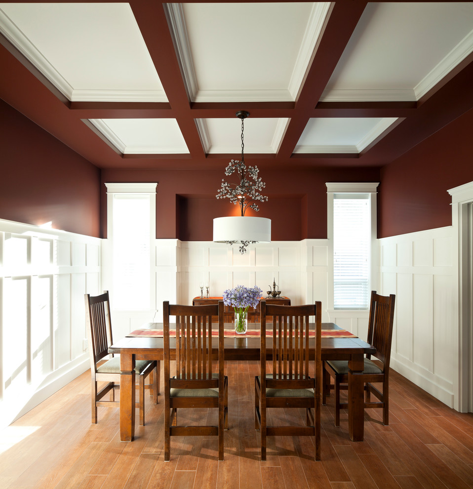 Inspiration for a traditional separate dining room in Vancouver with multi-coloured walls, medium hardwood floors and orange floor.
