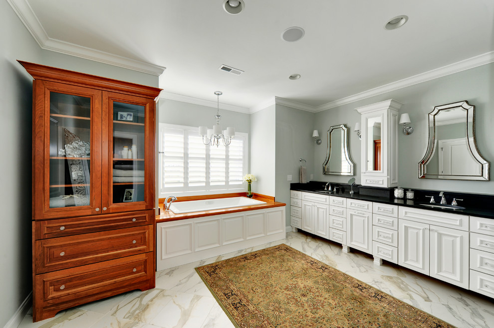 Design ideas for a large traditional master bathroom in Other with white cabinets, grey walls, marble floors, an undermount sink, white floor, a drop-in tub and raised-panel cabinets.