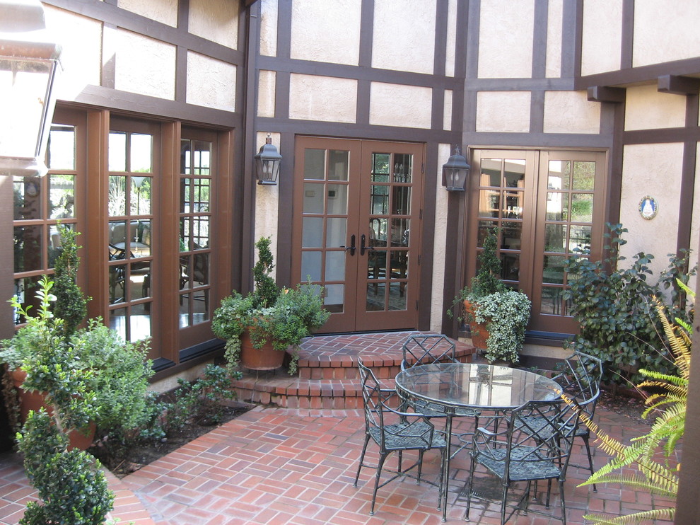 Design ideas for a mid-sized country backyard patio in San Francisco with brick pavers and no cover.