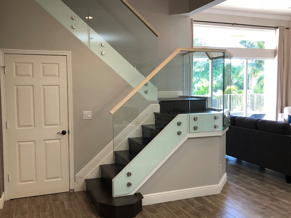 Mid-sized modern wood l-shaped staircase in Miami with wood risers and glass railing.