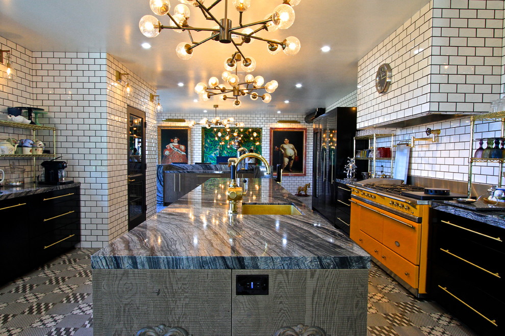 Enclosed kitchen - huge eclectic l-shaped ceramic tile enclosed kitchen idea in Orange County with an undermount sink, flat-panel cabinets, gray cabinets, marble countertops, white backsplash, subway tile backsplash, black appliances and an island