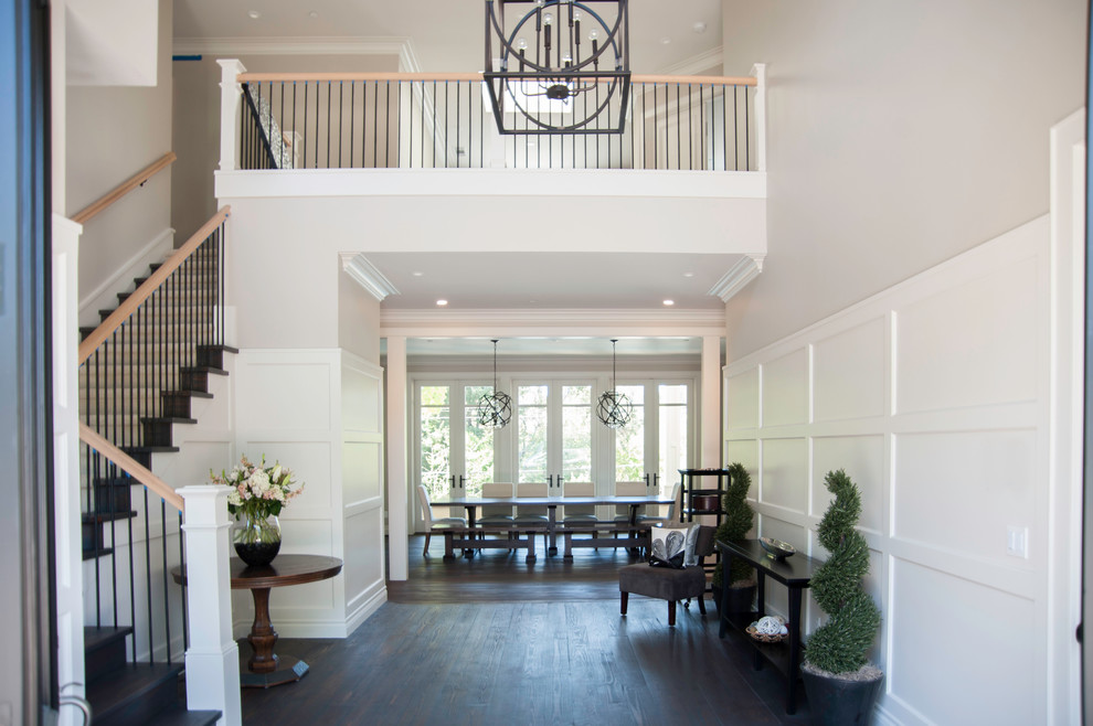 Inspiration for a large contemporary foyer in San Francisco with beige walls, dark hardwood floors, a double front door and a dark wood front door.