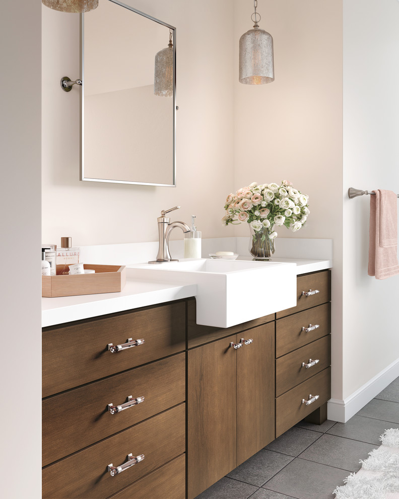 This is an example of a mid-sized transitional bathroom in Other with flat-panel cabinets, medium wood cabinets, pink walls, ceramic floors, grey floor and white benchtops.