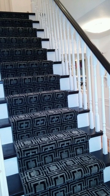 Staircase - mid-sized transitional carpeted straight wood railing staircase idea in Toronto with painted risers