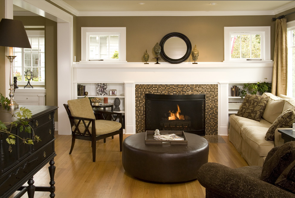 This is an example of a traditional living room in Seattle with a tile fireplace surround.