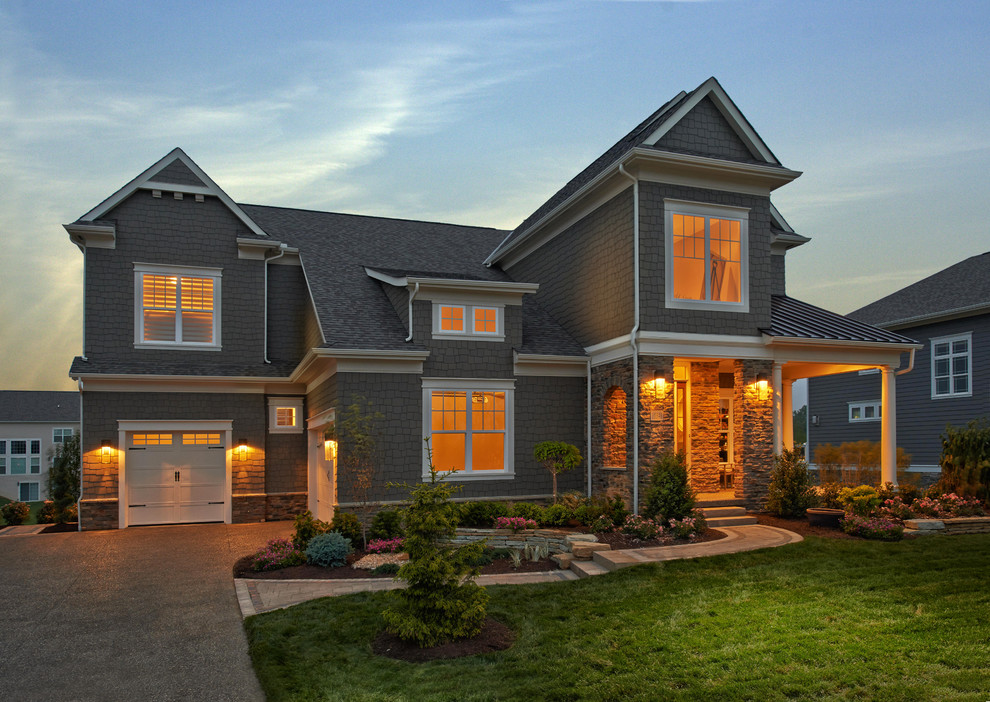 Large traditional three-storey grey exterior in Columbus with wood siding and a gable roof.