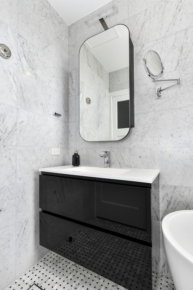 Design ideas for a small contemporary bathroom in Sydney with black cabinets, a freestanding tub, an alcove shower, a wall-mount toilet, gray tile, grey walls, mosaic tile floors and a sliding shower screen.