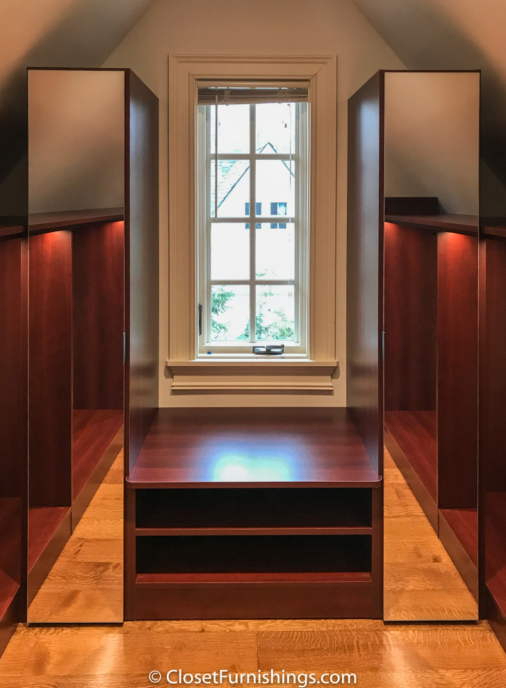 This is an example of a mid-sized modern gender-neutral walk-in wardrobe in Chicago with flat-panel cabinets, red cabinets and dark hardwood floors.