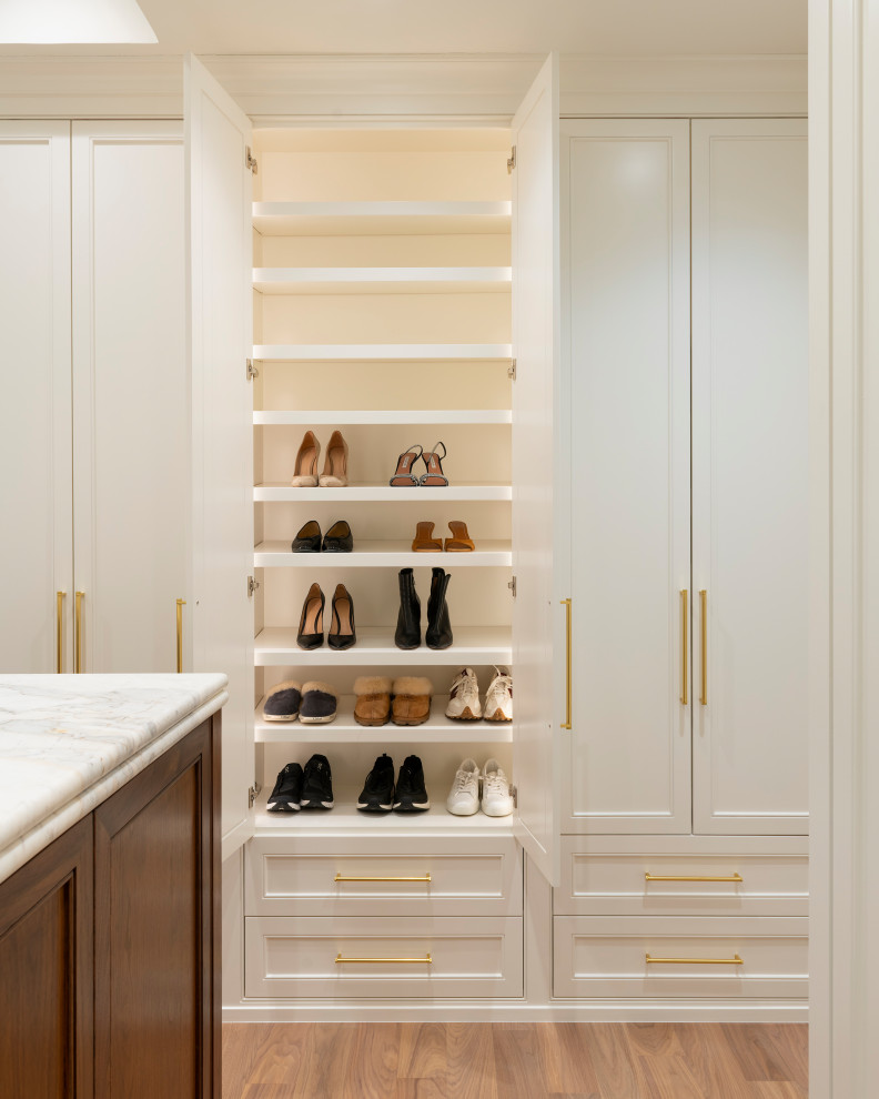 Walk-in closet - large transitional women's medium tone wood floor walk-in closet idea in Dallas with shaker cabinets and white cabinets