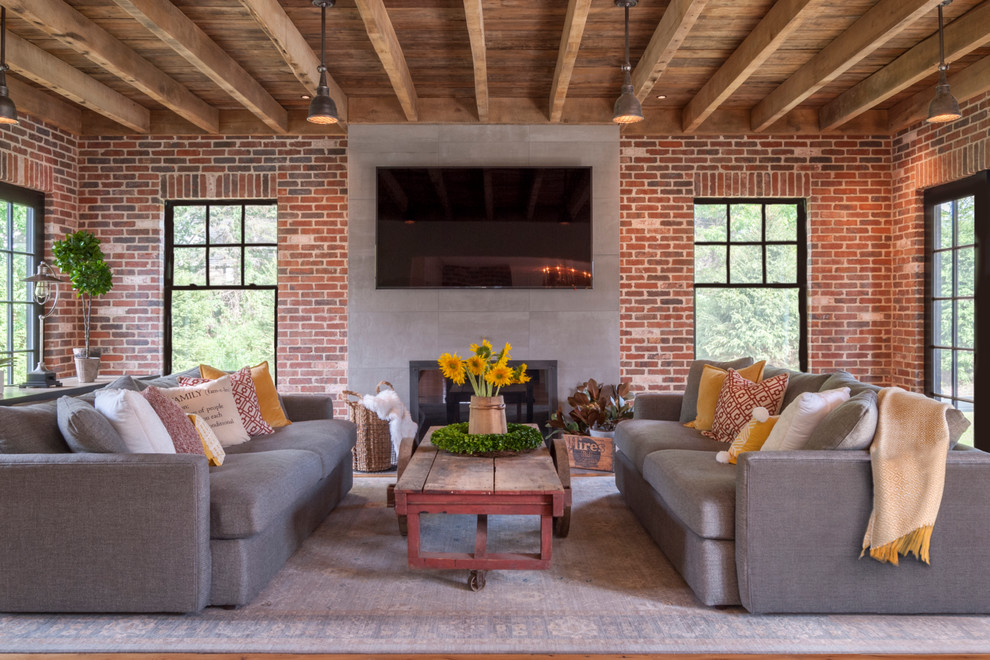 Inspiration for a mid-sized country loft-style family room in Cleveland with light hardwood floors, a standard fireplace, a concrete fireplace surround and a wall-mounted tv.