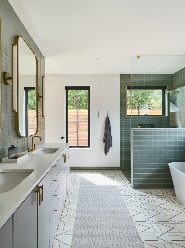 Design ideas for a contemporary master bathroom in Austin with flat-panel cabinets, grey cabinets, a freestanding tub, a corner shower, green tile, white walls, an undermount sink, white floor, an open shower, white benchtops, a double vanity and a built-in vanity.