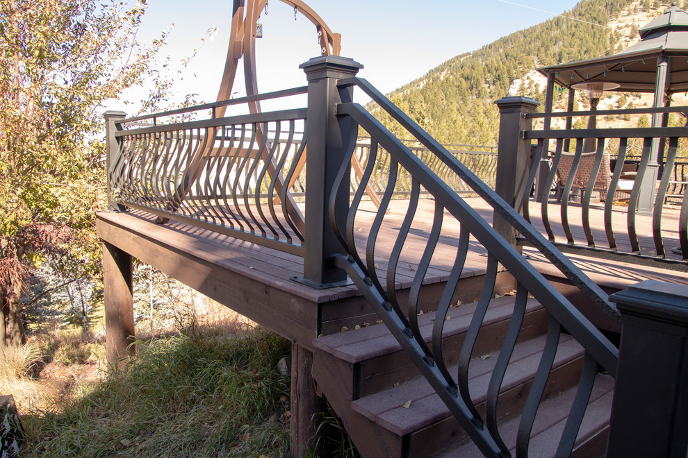 Inspiration for a large rustic backyard deck remodel with no cover