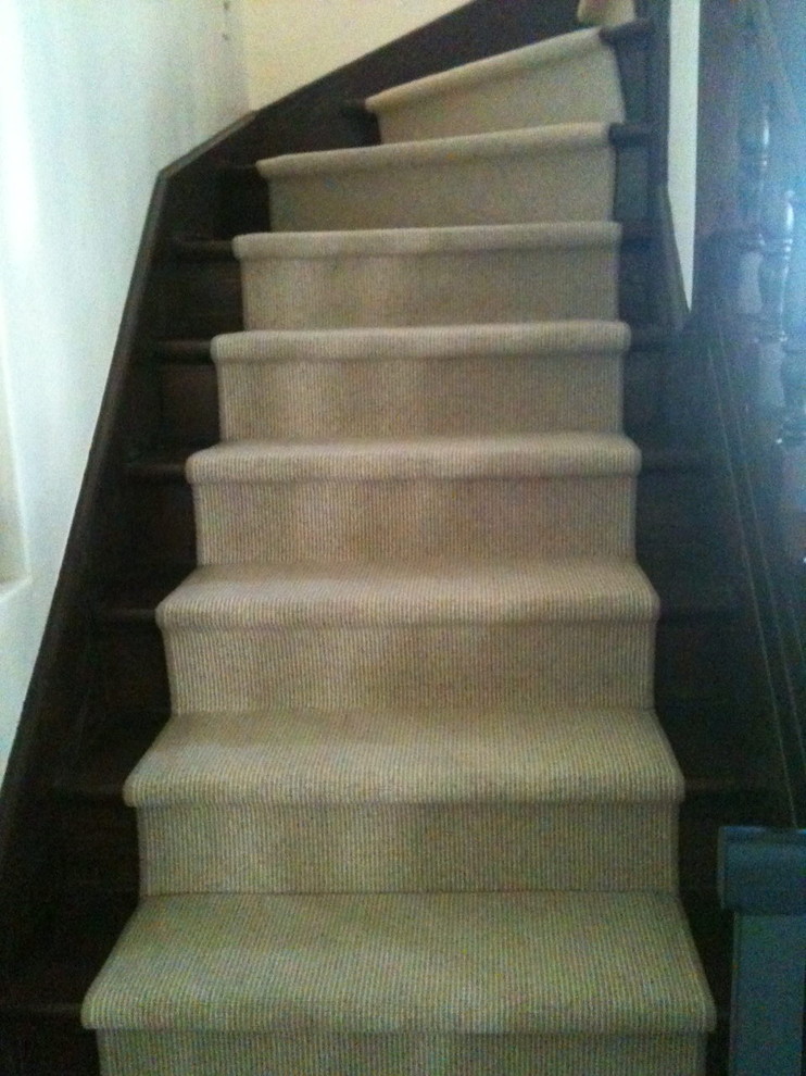 Photo of a mid-sized traditional wood curved staircase in Los Angeles with wood risers.