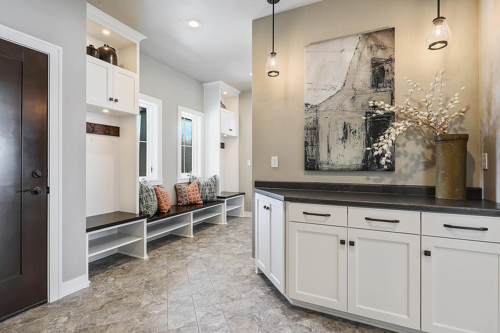 Mudroom - large transitional porcelain tile and beige floor mudroom idea with beige walls and a dark wood front door