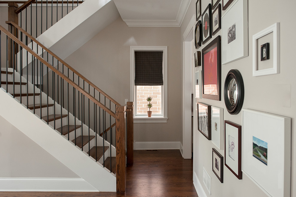 Photo of a mid-sized transitional wood u-shaped staircase in Chicago with painted wood risers and mixed railing.
