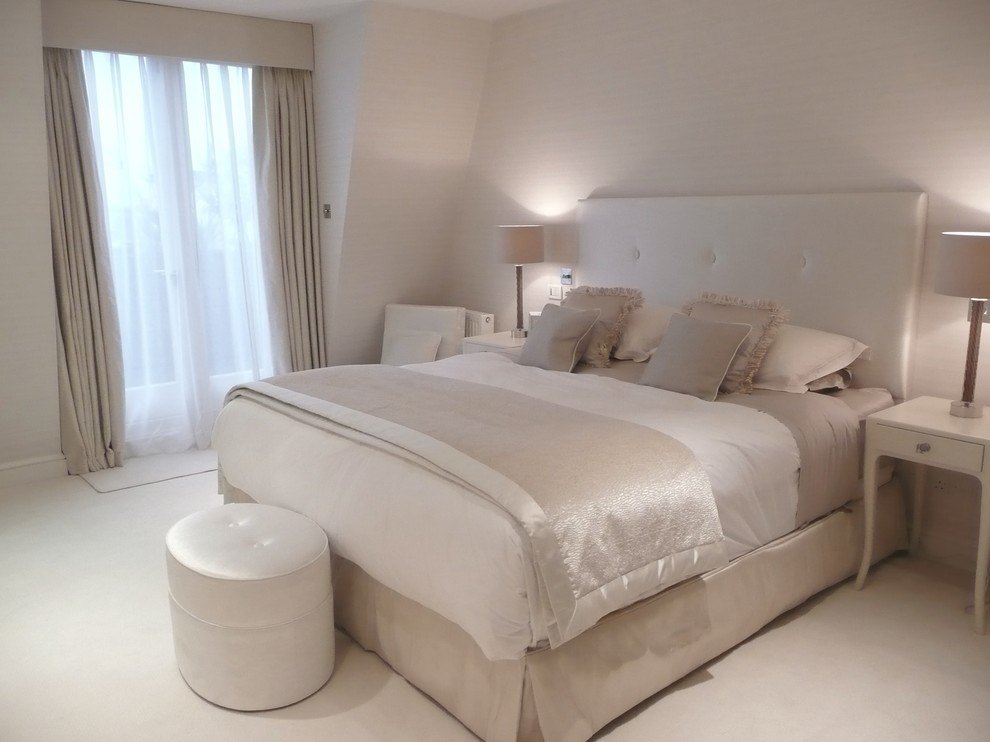 Transitional bedroom in London with beige walls.