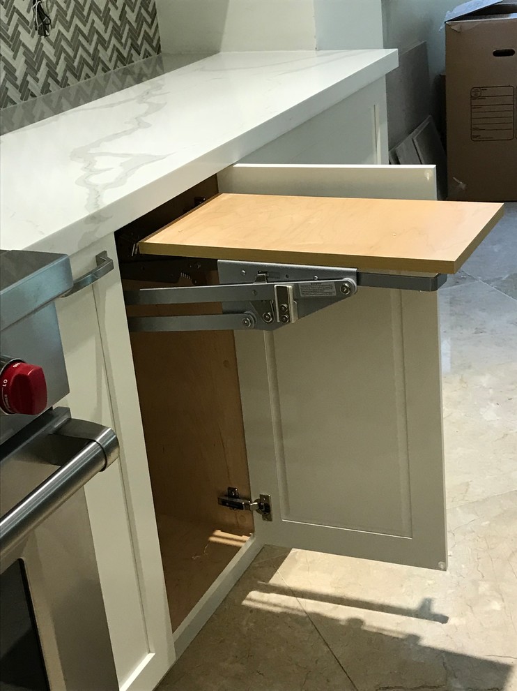Example of a large transitional kitchen design in Miami with a farmhouse sink, shaker cabinets, white cabinets, quartz countertops, gray backsplash, glass tile backsplash, stainless steel appliances, an island and multicolored countertops