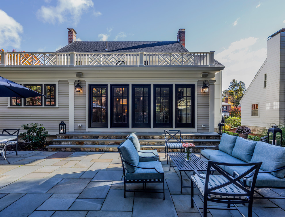 Example of a huge transitional backyard patio design in Boston with no cover