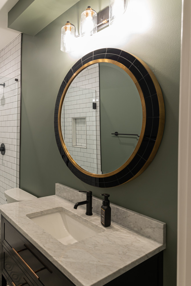 Mid-sized transitional bathroom in Chicago with furniture-like cabinets, black cabinets, an alcove shower, a two-piece toilet, white tile, ceramic tile, green walls, ceramic floors, an undermount sink, marble benchtops, black floor, a hinged shower door, grey benchtops, a niche, a single vanity and a freestanding vanity.