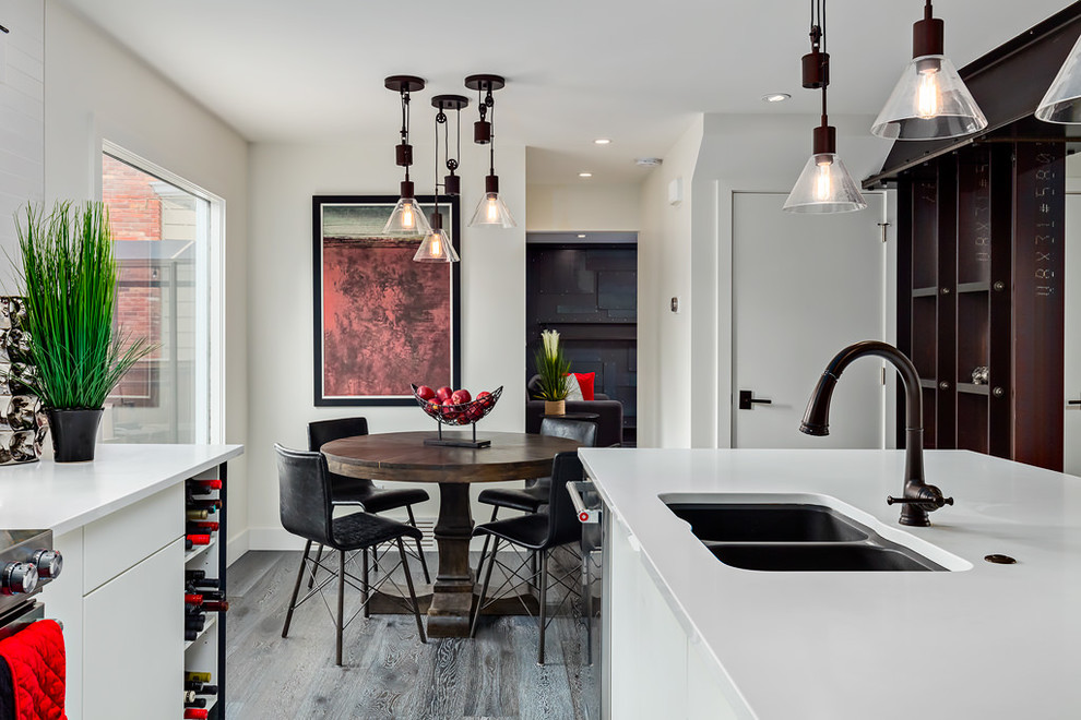 Photo of a large open plan kitchen in Calgary with an undermount sink, flat-panel cabinets, white cabinets, quartzite benchtops, dark hardwood floors and with island.