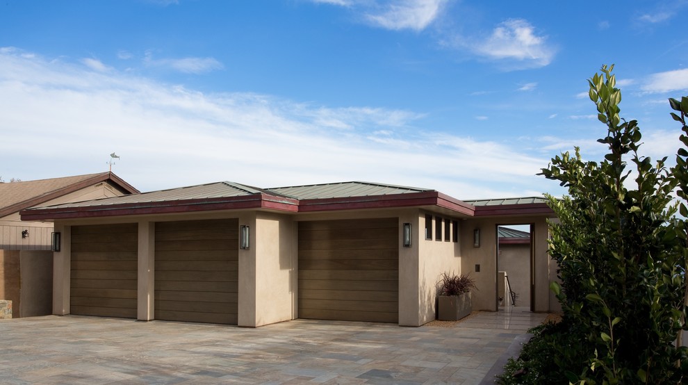 Design ideas for a large modern attached three-car garage in Orange County.