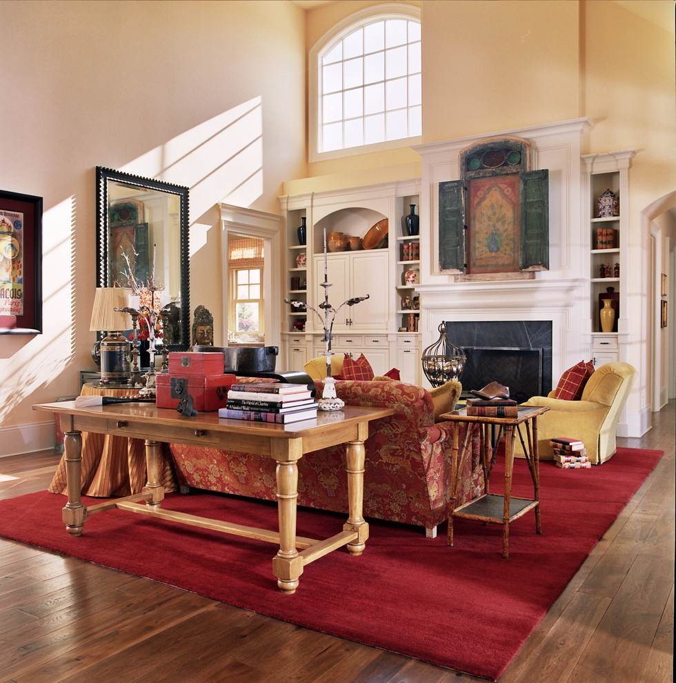 Traditional living room in Portland with yellow walls and a concealed tv.