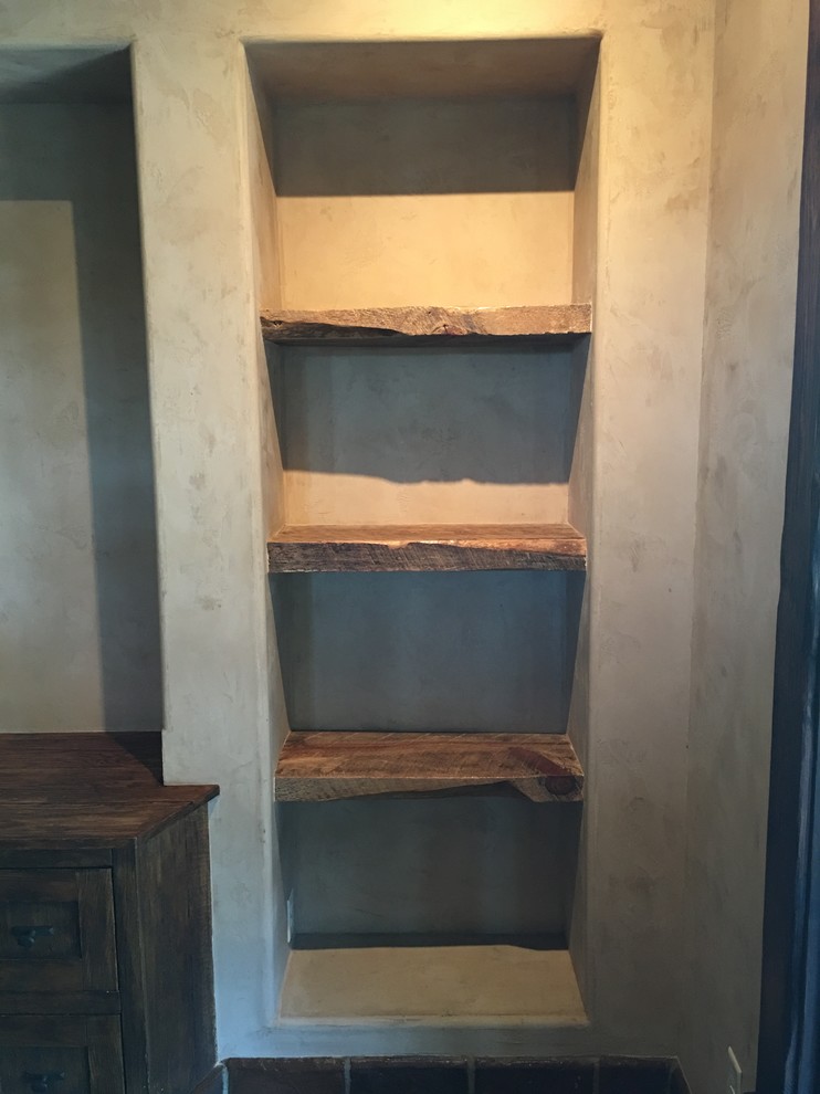 Example of a mountain style built-in desk home design design in Austin with beige walls