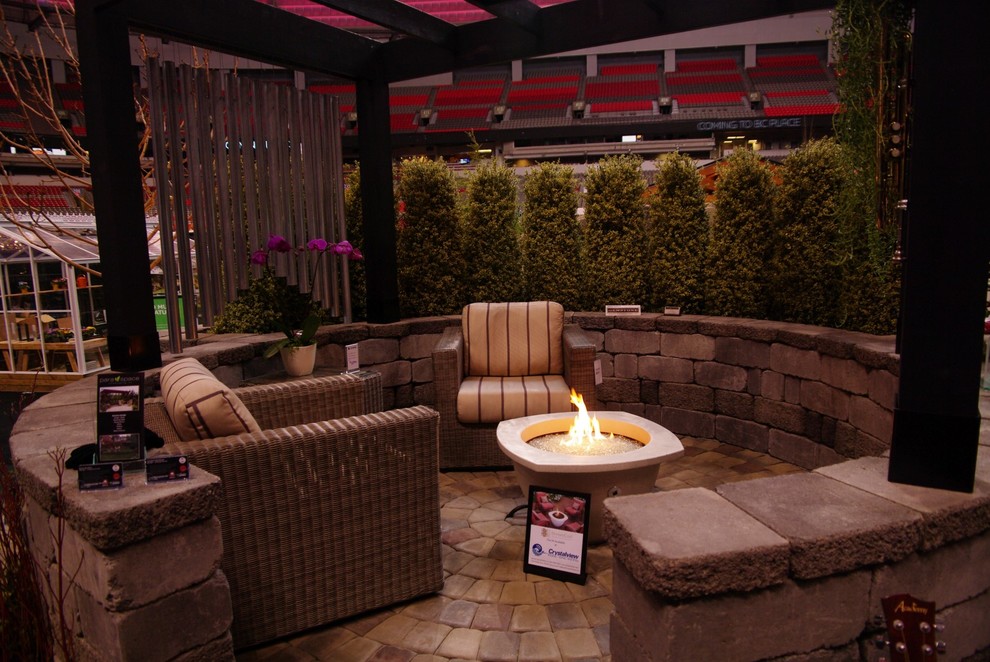 This is an example of a contemporary backyard patio in Vancouver with a fire feature.