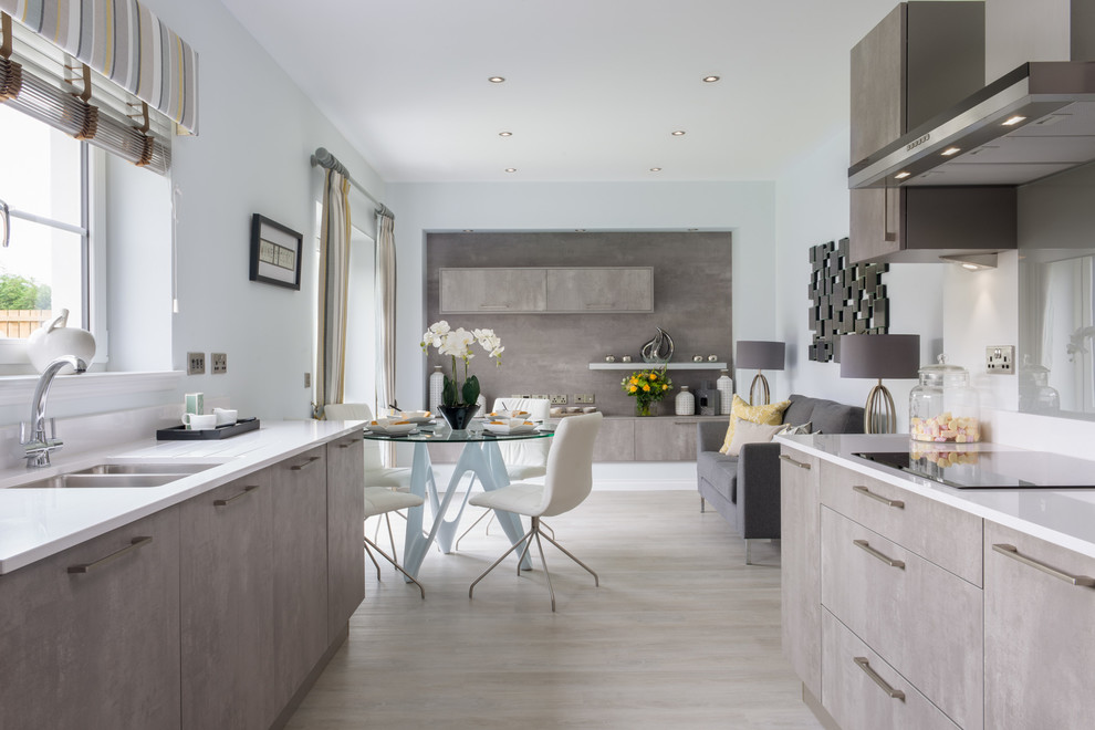 Inspiration for a contemporary open plan kitchen in London with a double-bowl sink, flat-panel cabinets, grey cabinets, light hardwood floors and no island.