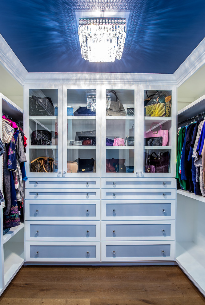 Inspiration for a mid-sized transitional walk-in wardrobe in Los Angeles with shaker cabinets, blue cabinets and medium hardwood floors.