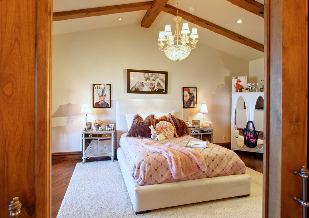 Photo of an expansive traditional guest bedroom in Phoenix with beige walls, medium hardwood floors, a standard fireplace and a stone fireplace surround.