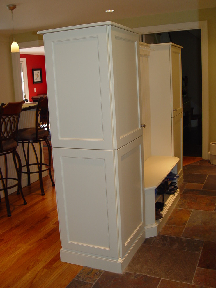 Kitchen - transitional kitchen idea in Boston with an undermount sink, recessed-panel cabinets, white cabinets, granite countertops, black appliances and an island