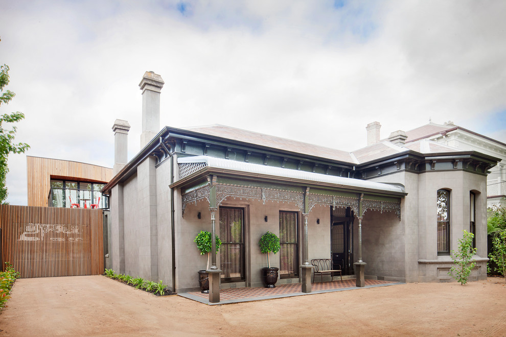 This is an example of an expansive traditional one-storey concrete grey exterior in Melbourne with a hip roof.