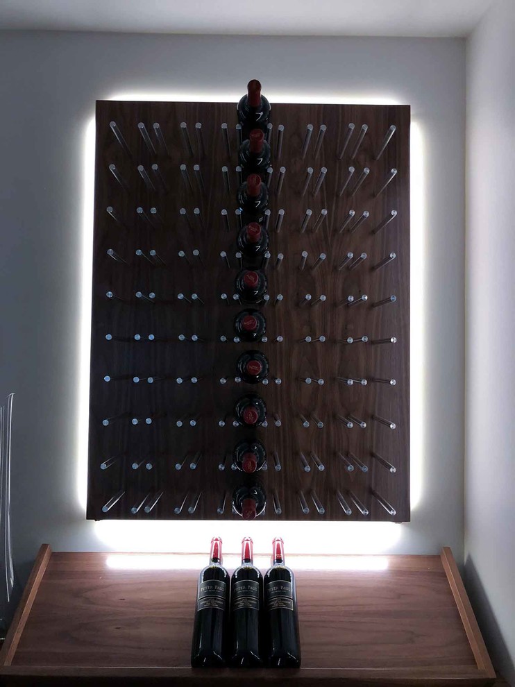 Mid-sized transitional wine cellar in Philadelphia with laminate floors, display racks and grey floor.