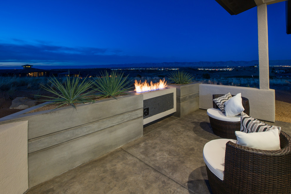 Patio - mid-sized contemporary backyard concrete paver patio idea with a fireplace and a roof extension