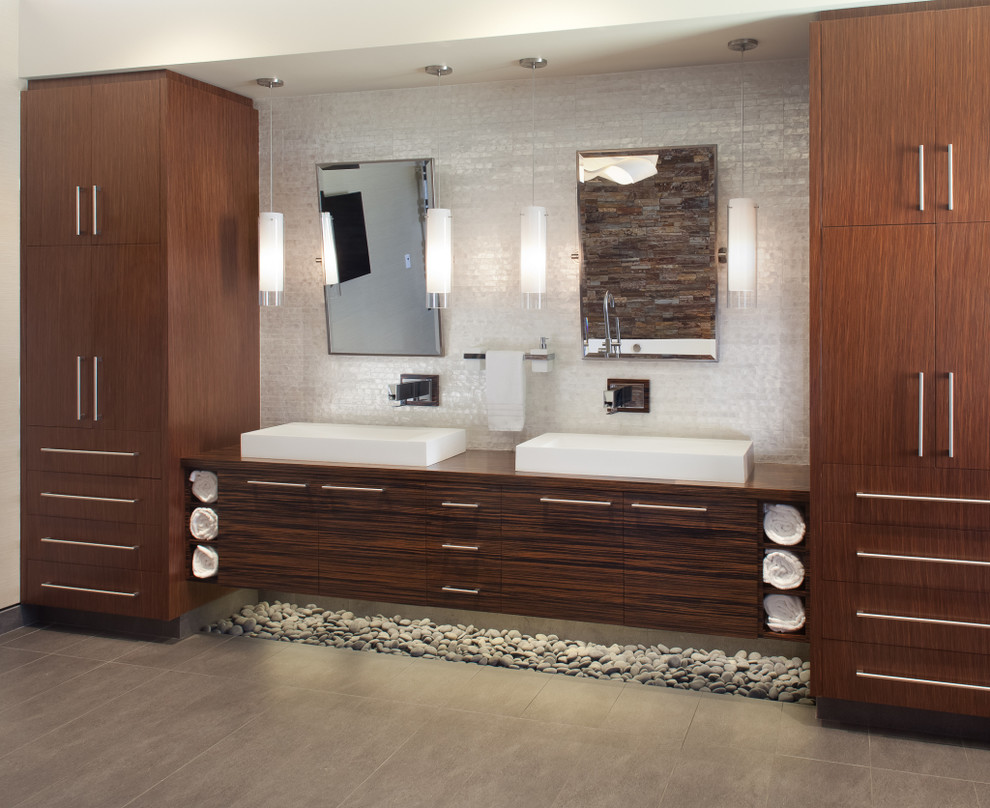 This is an example of a large contemporary master bathroom in Austin with flat-panel cabinets, brown cabinets, a japanese tub, an open shower, a two-piece toilet, beige tile, cement tile, beige walls, cement tiles, a vessel sink, wood benchtops, beige floor and an open shower.