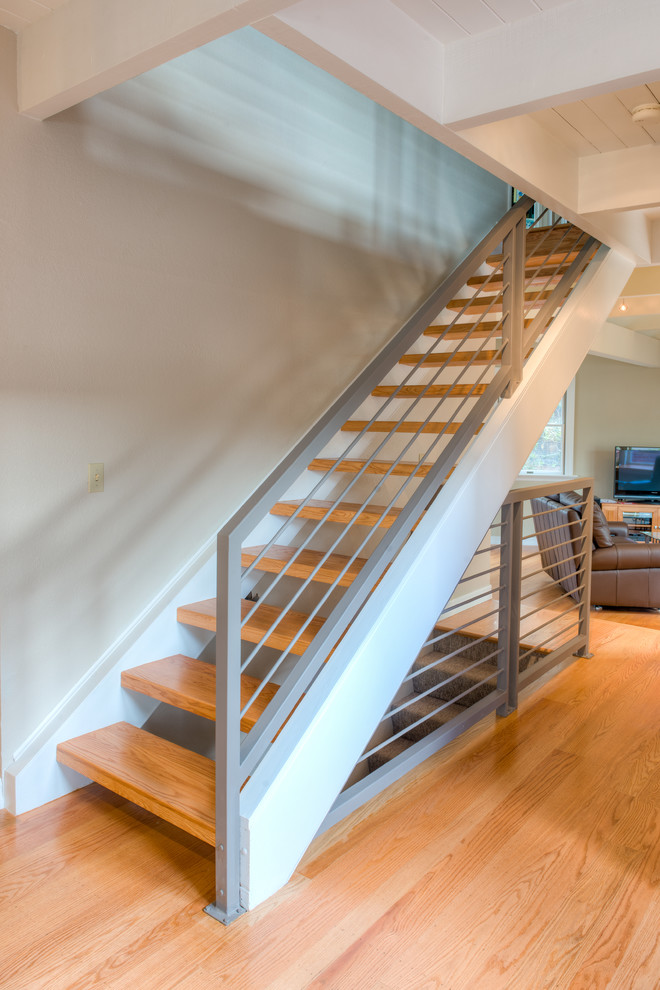 Inspiration for a mid-sized contemporary wood straight staircase in San Francisco with open risers and metal railing.