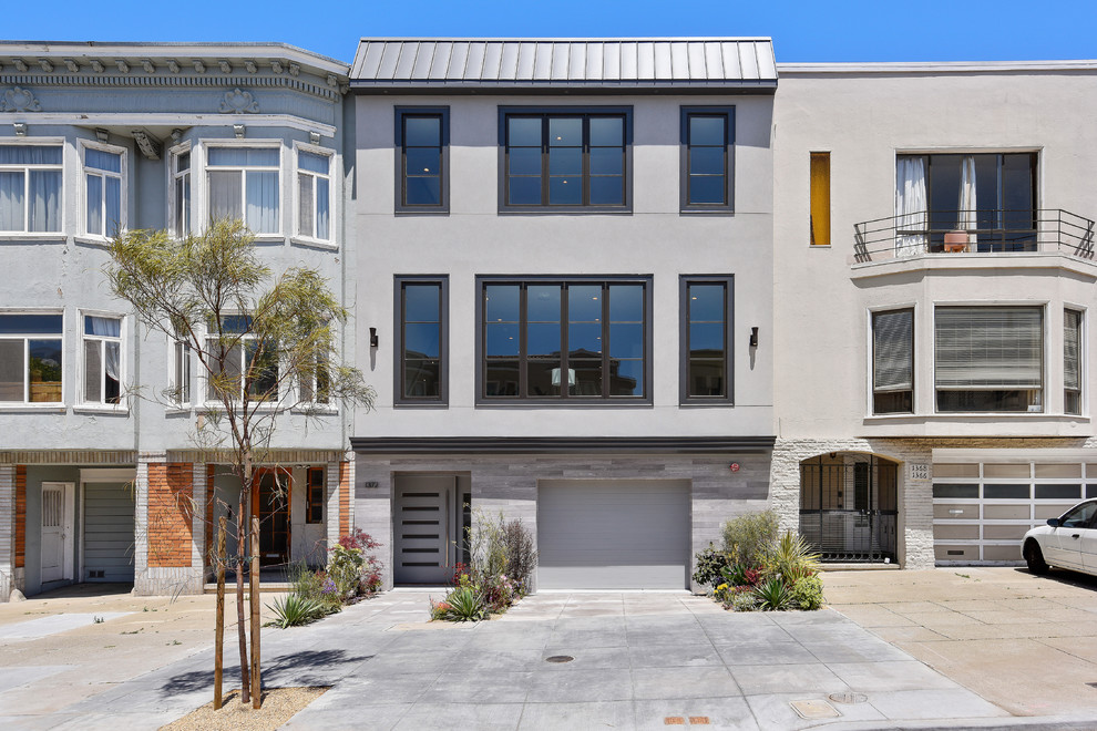 Contemporary three-storey grey house exterior in San Francisco with mixed siding and a metal roof.