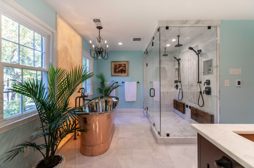 This is an example of a small contemporary master bathroom in DC Metro with dark wood cabinets, a freestanding tub, a double shower, a one-piece toilet, blue walls, marble floors, marble benchtops, grey floor, a hinged shower door, white benchtops, a shower seat, a double vanity and a floating vanity.