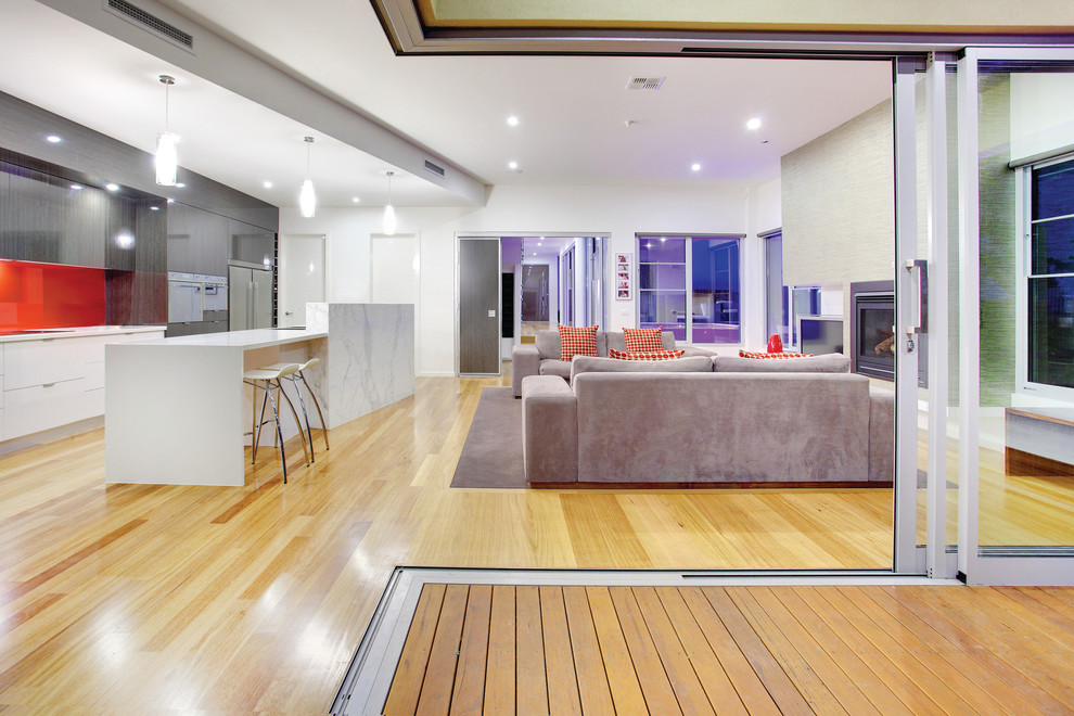 Inspiration for a contemporary open concept living room in Melbourne with a standard fireplace and yellow floor.