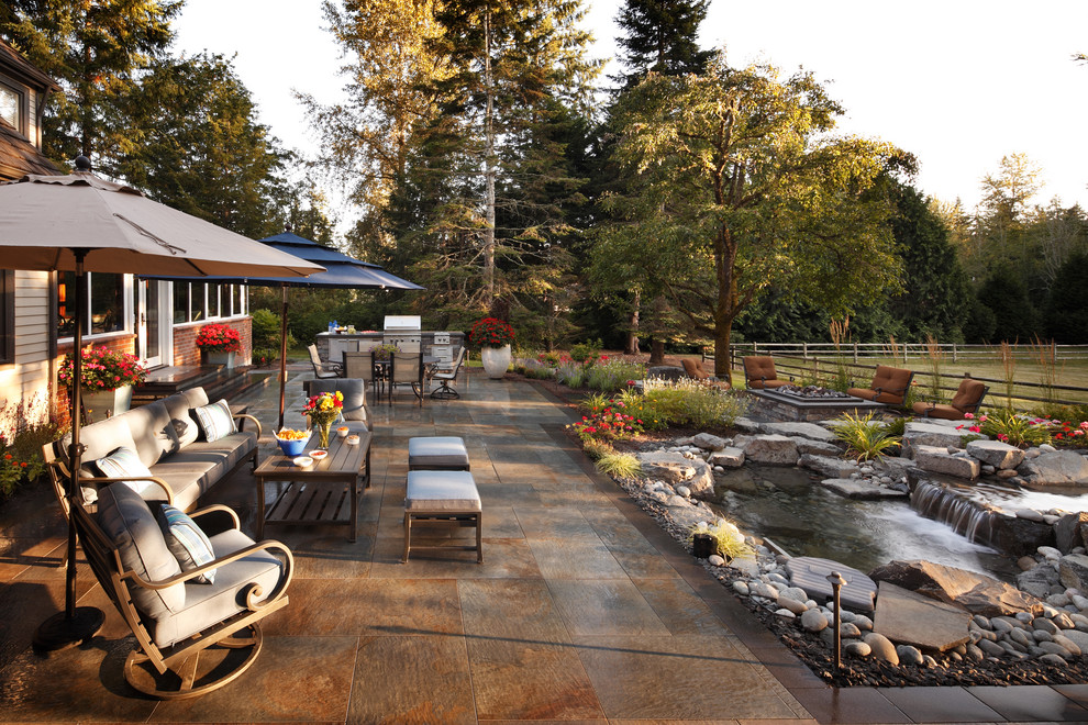 This is an example of a contemporary backyard patio in Seattle with an outdoor kitchen.