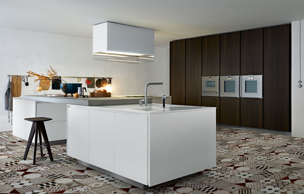 This is an example of a large contemporary l-shaped separate kitchen in Rennes with dark wood cabinets and with island.